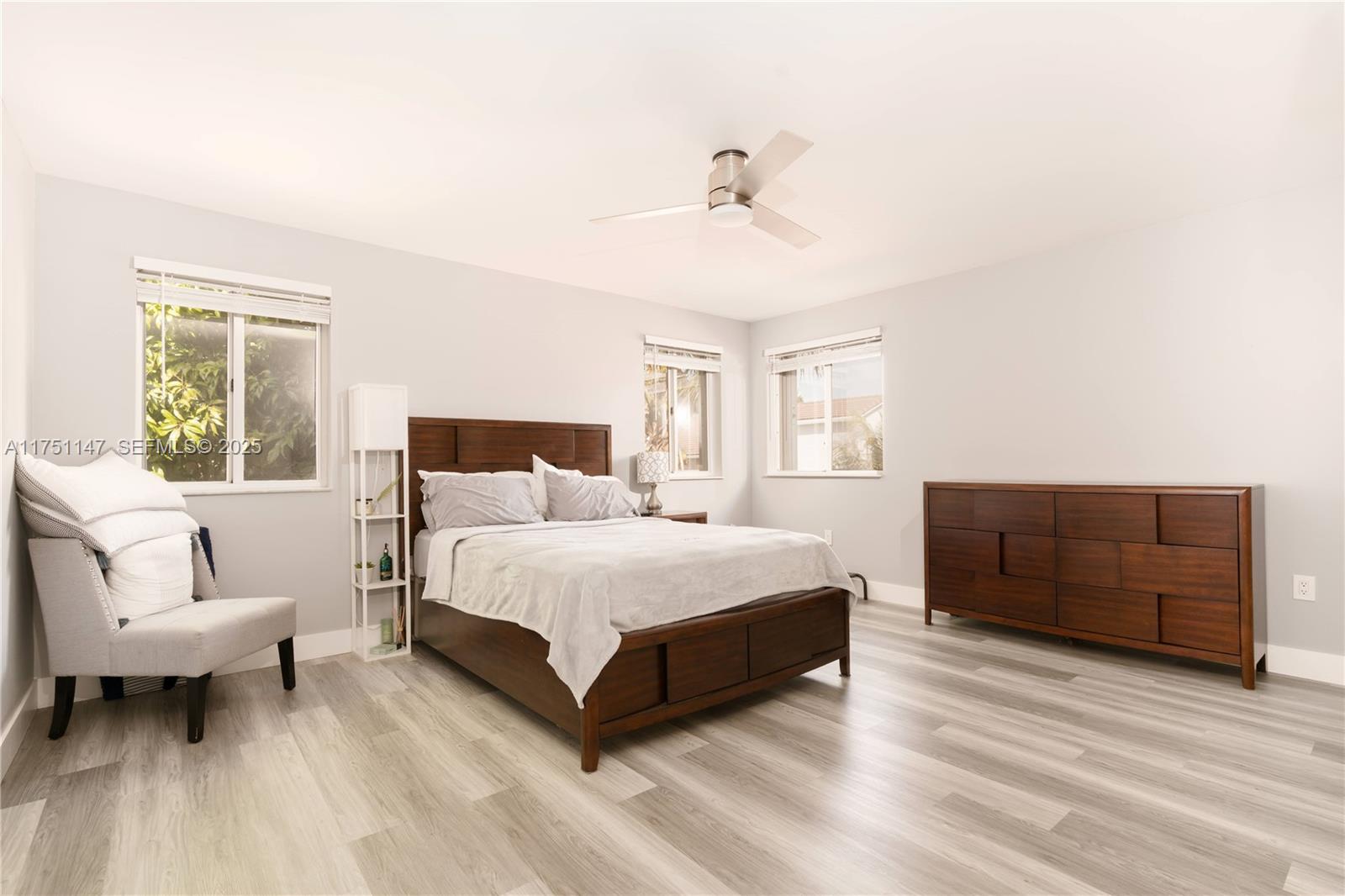 19444 Northwest 79th Court Hialeah, FL 33015 - Photo 17 of 26 a spacious bedroom with a bed and a couch