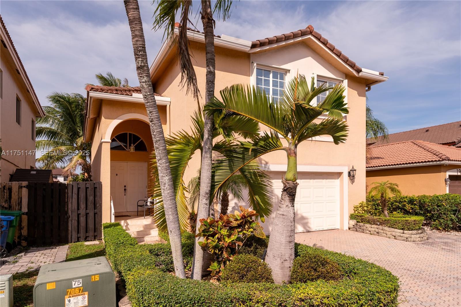 19444 Northwest 79th Court Hialeah, FL 33015 - Photo 4 of 26 a front view of a house with a yard