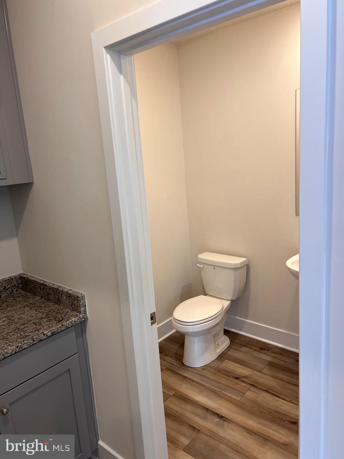 13927 Anderson Garden Road Laurel, MD 20707 - Photo 24 of 31 a bathroom with a granite countertop toilet and a sink