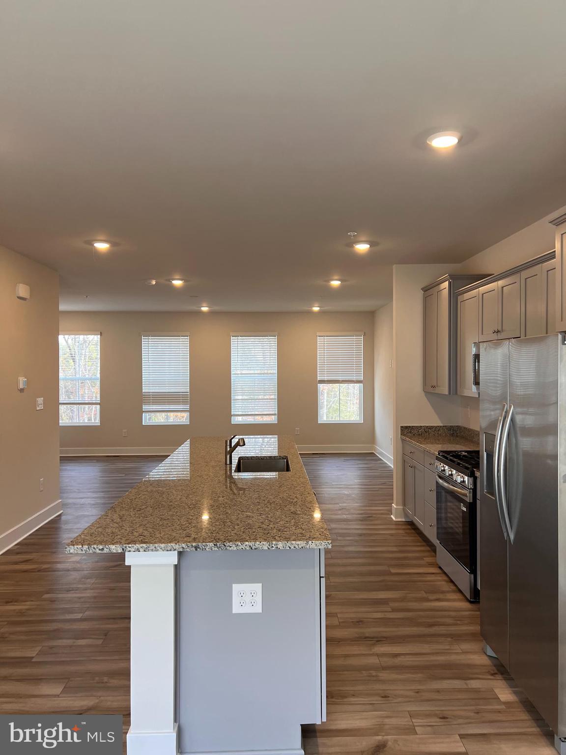 13927 Anderson Garden Road Laurel, MD 20707 - Photo 25 of 31 a kitchen with stainless steel appliances granite countertop a sink stove and refrigerator