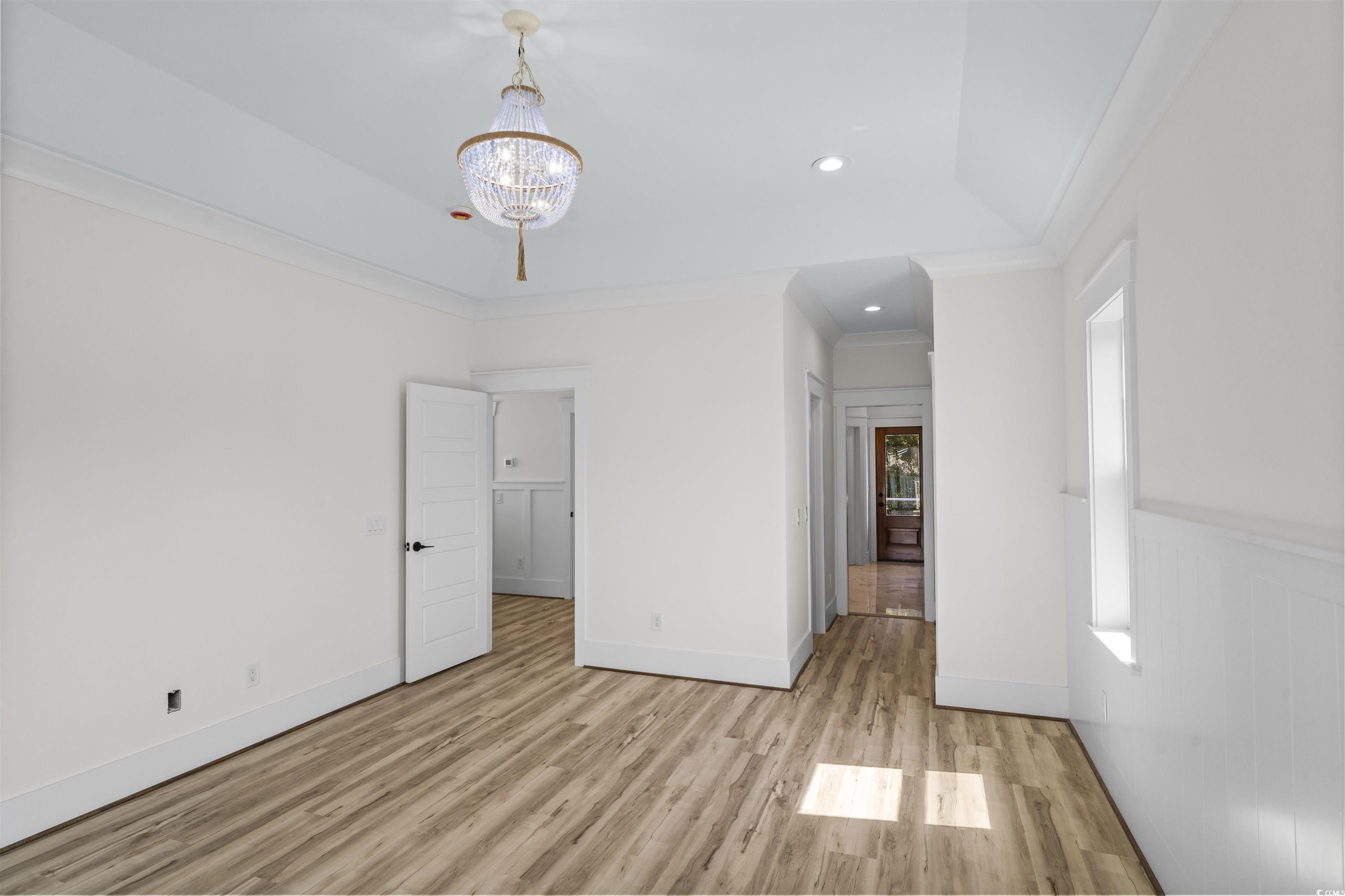 1017 Hyatt Pond Road North Myrtle Beach, SC 29582 - Photo 13 of 39 Unfurnished bedroom with wood finished floors, a chandelier, crown molding, and recessed lighting