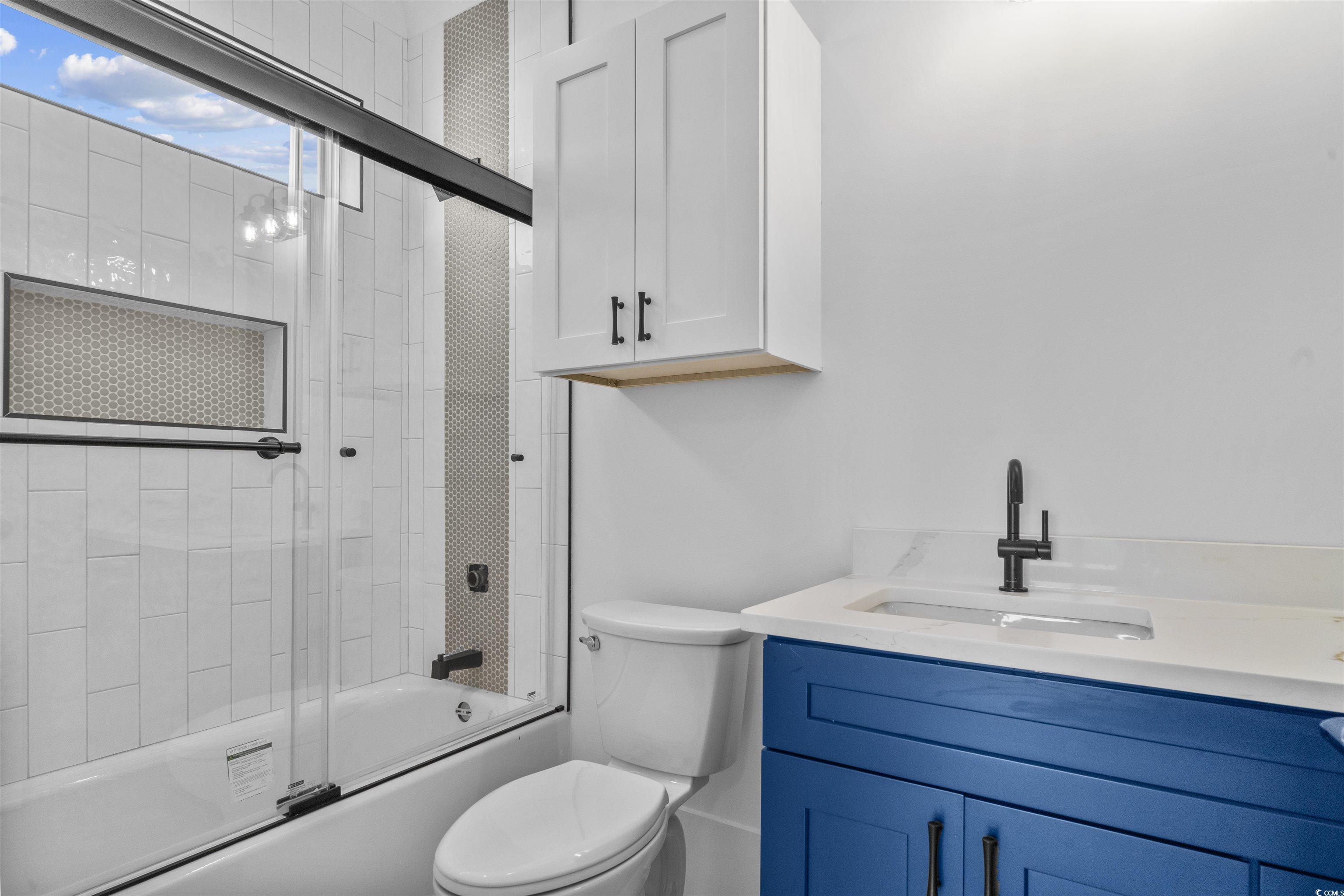1017 Hyatt Pond Road North Myrtle Beach, SC 29582 - Photo 19 of 39 Bathroom featuring combined bath / shower with glass door and vanity