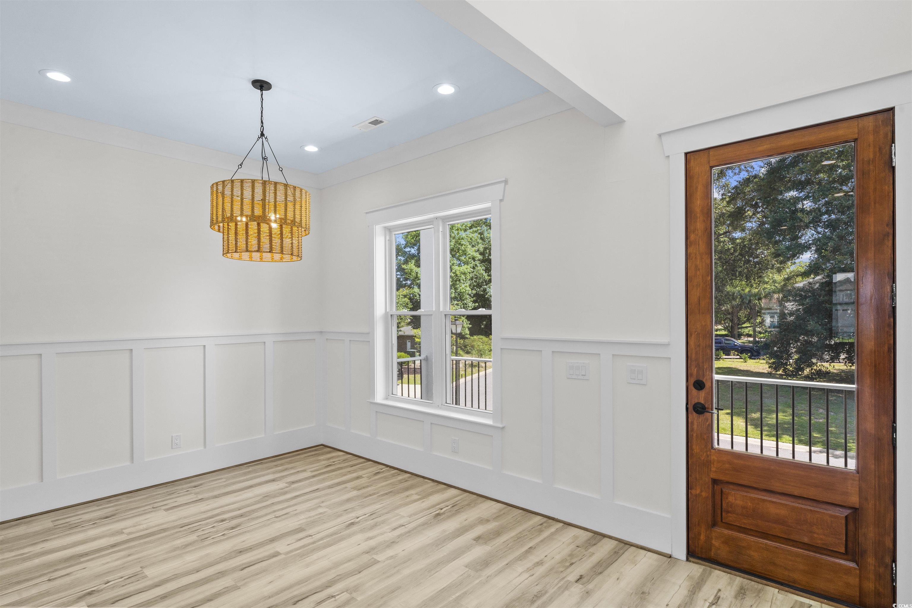 1017 Hyatt Pond Road North Myrtle Beach, SC 29582 - Photo 7 of 39 Entrance foyer featuring a chandelier, a decorative wall, light wood-type flooring, a wainscoted wall, and recessed lighting