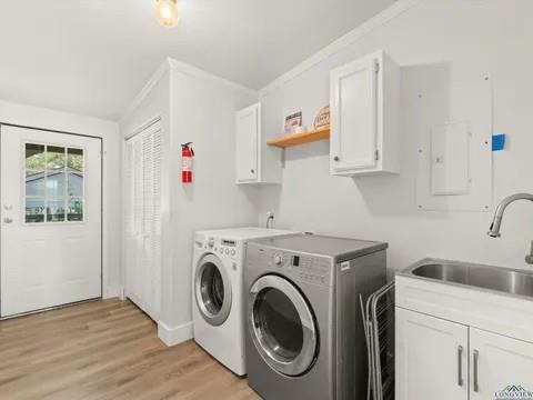 429 Private Road Big Sandy, TX 75755 - Photo 15 of 24 Washroom with cabinet space, light wood-type flooring, and washer and dryer