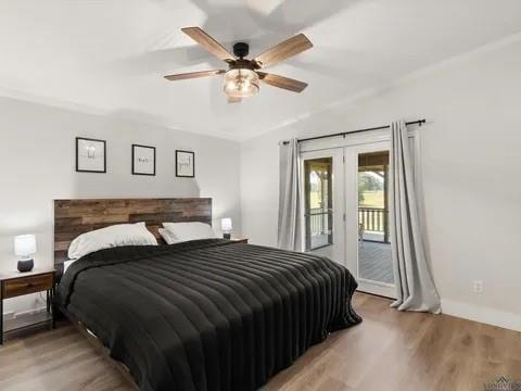 429 Private Road Big Sandy, TX 75755 - Photo 21 of 24 Bedroom featuring french doors, light wood-type flooring, access to exterior, and a ceiling fan