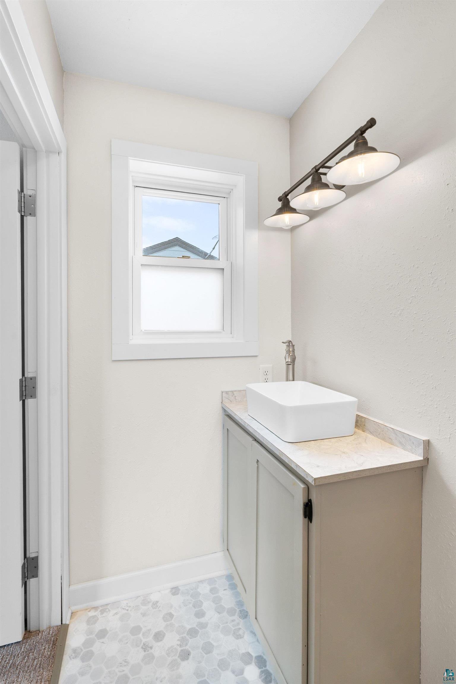 524 14th Avenue Two Harbors, MN 55616 - Photo 14 of 36 Bathroom featuring vanity and baseboards