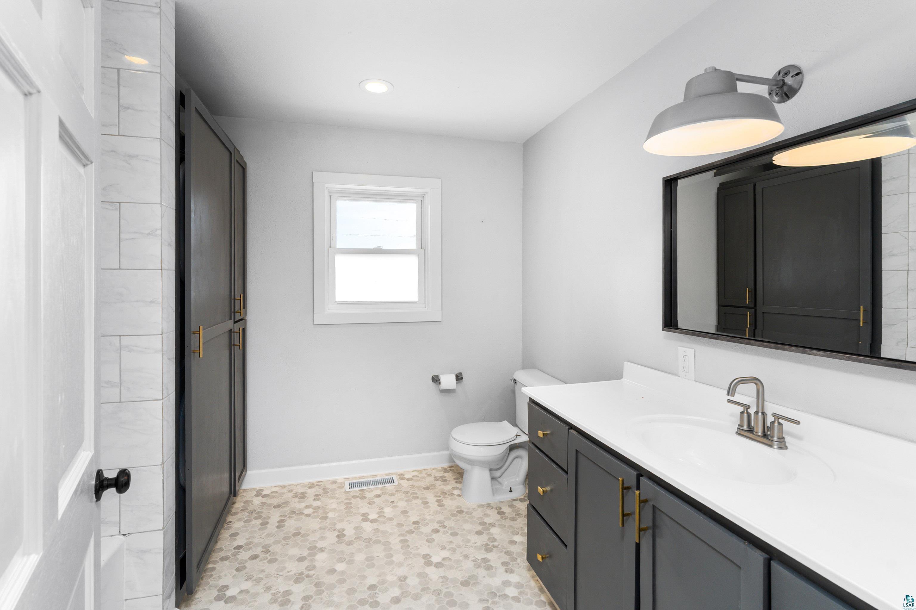 524 14th Avenue Two Harbors, MN 55616 - Photo 16 of 36 Bathroom featuring vanity and an enclosed shower
