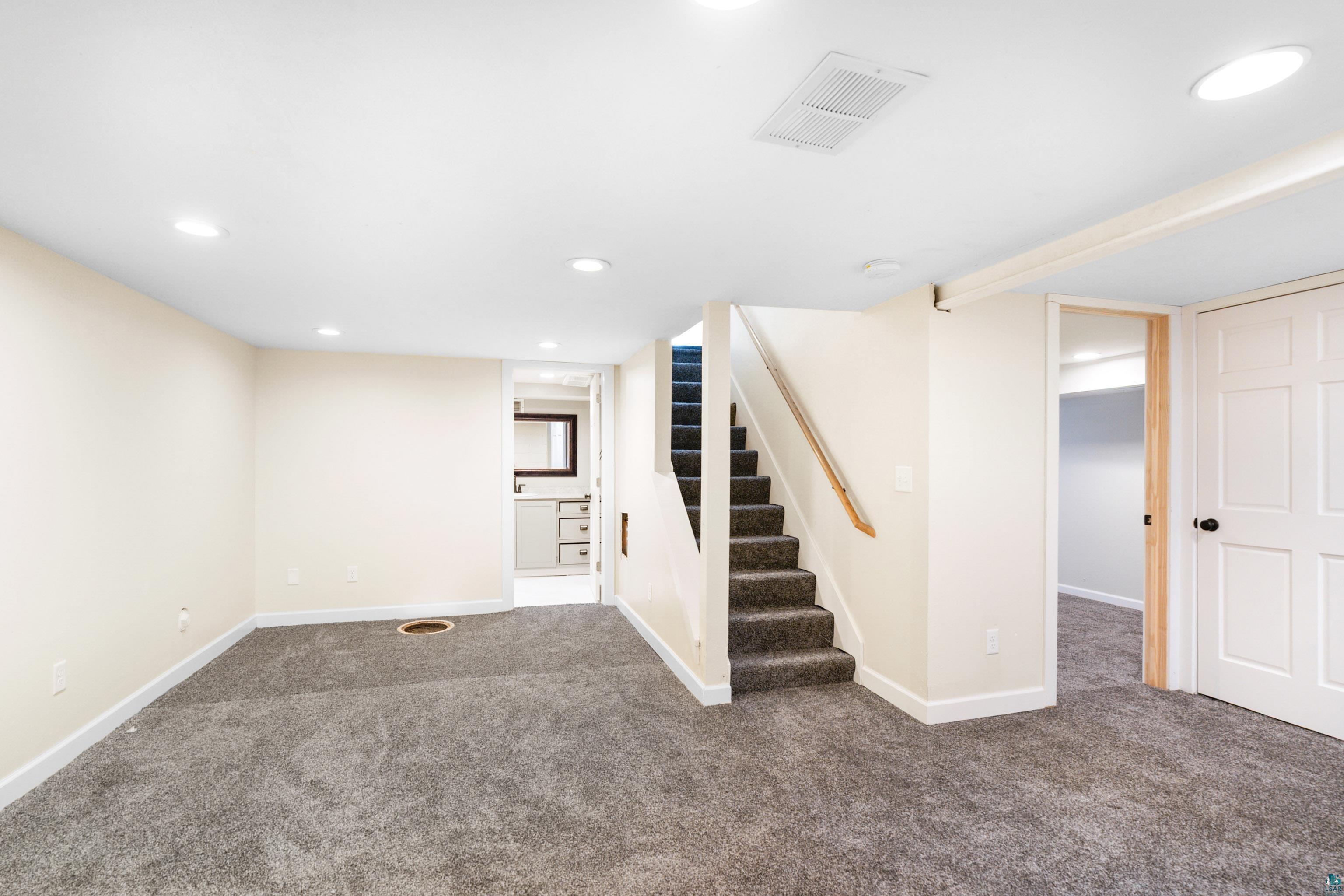 524 14th Avenue Two Harbors, MN 55616 - Photo 18 of 36 Finished basement with recessed lighting, carpet floors, and stairs