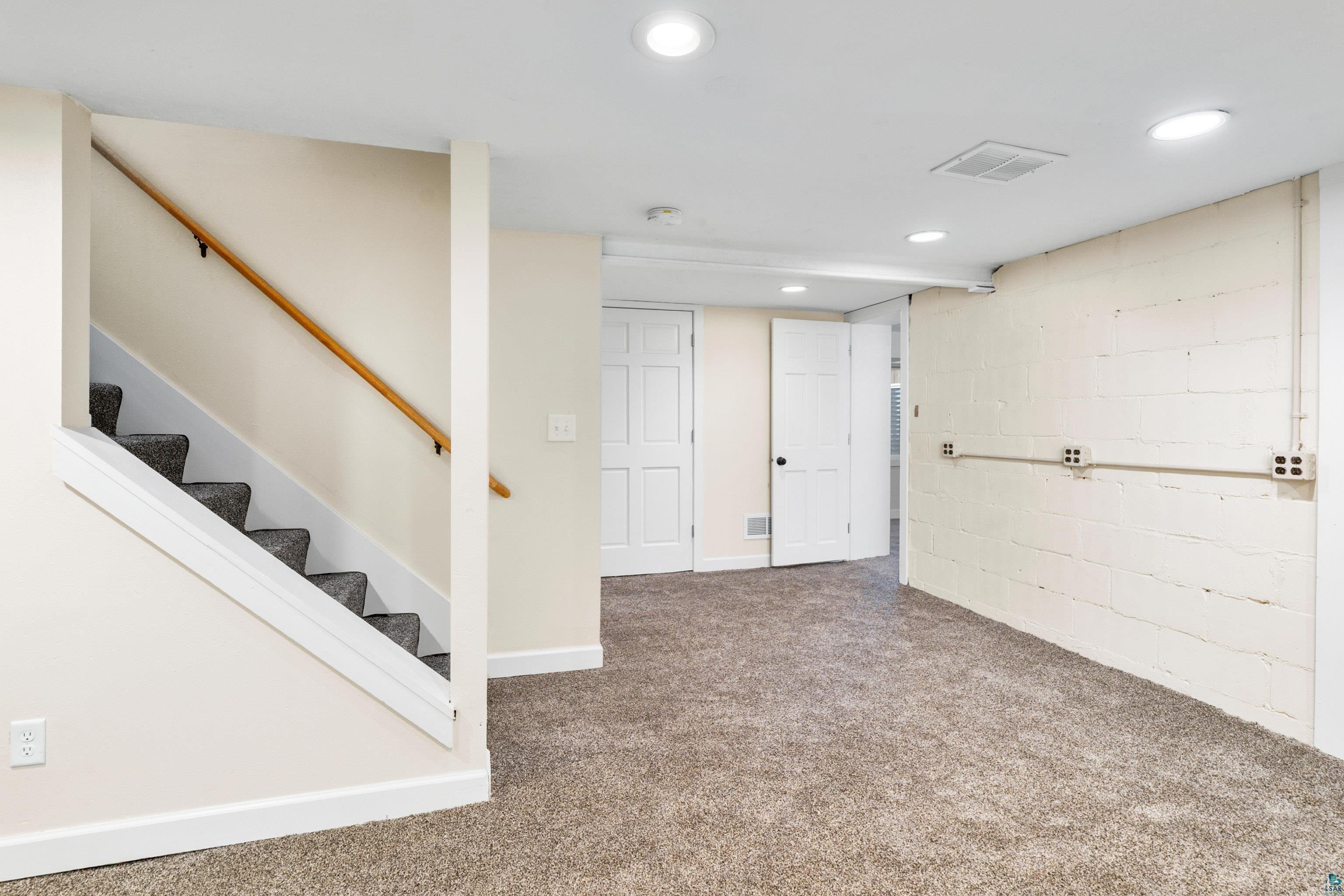 524 14th Avenue Two Harbors, MN 55616 - Photo 20 of 36 Finished below grade area featuring concrete block wall, carpet flooring, recessed lighting, and stairs