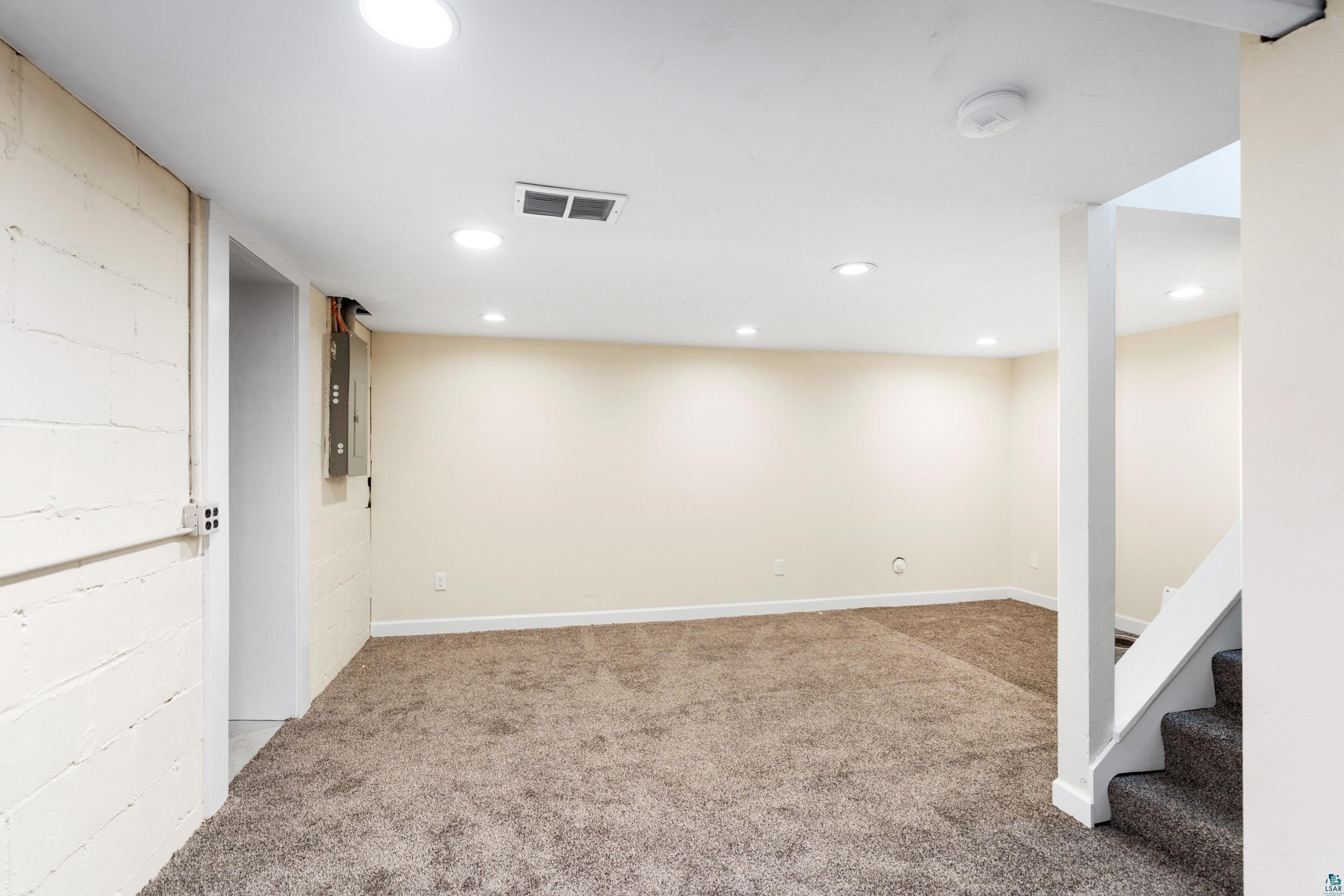 524 14th Avenue Two Harbors, MN 55616 - Photo 21 of 36 Finished below grade area with light carpet, recessed lighting, and electric panel