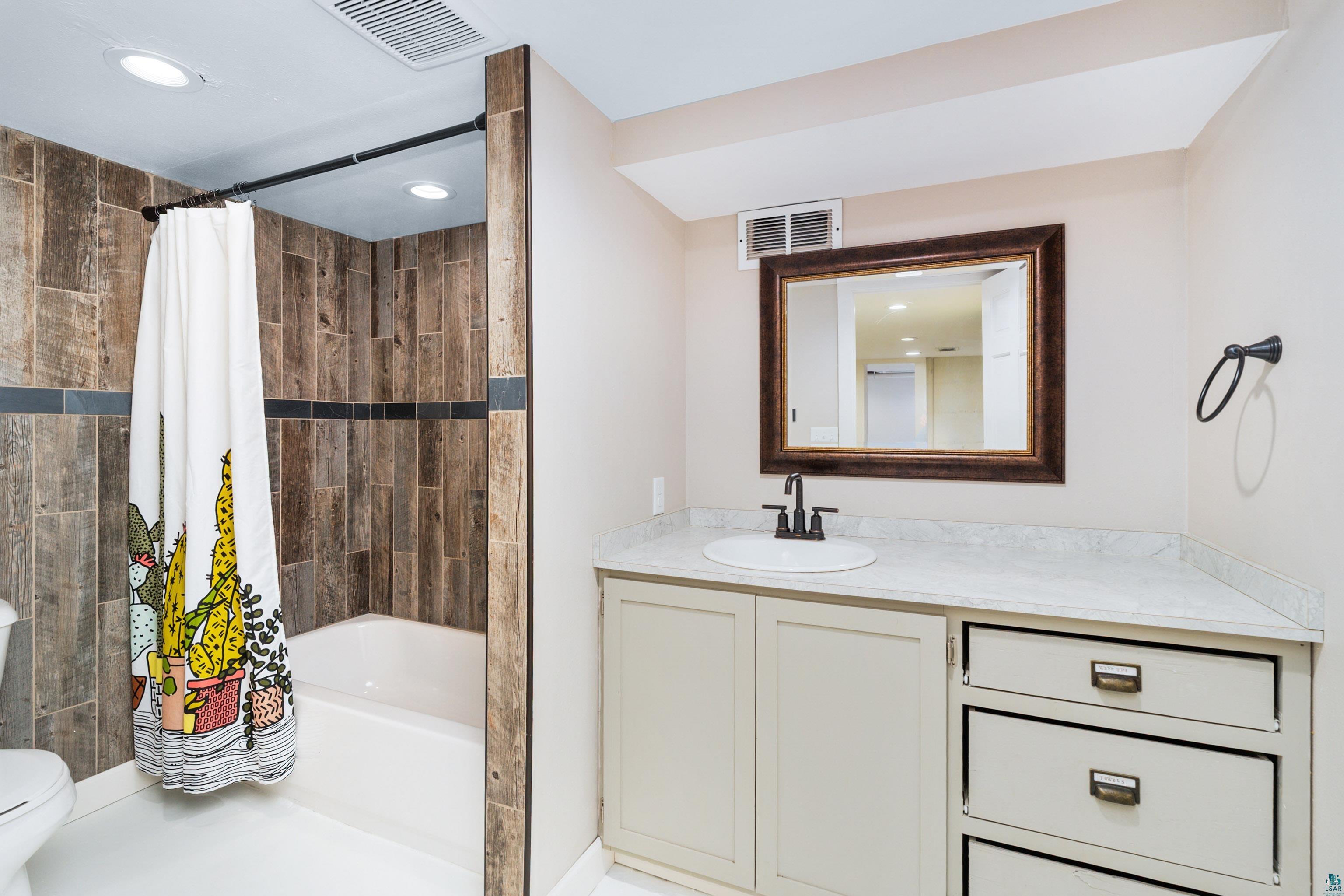 524 14th Avenue Two Harbors, MN 55616 - Photo 24 of 36 Full bathroom with shower / tub combo, vanity, and recessed lighting