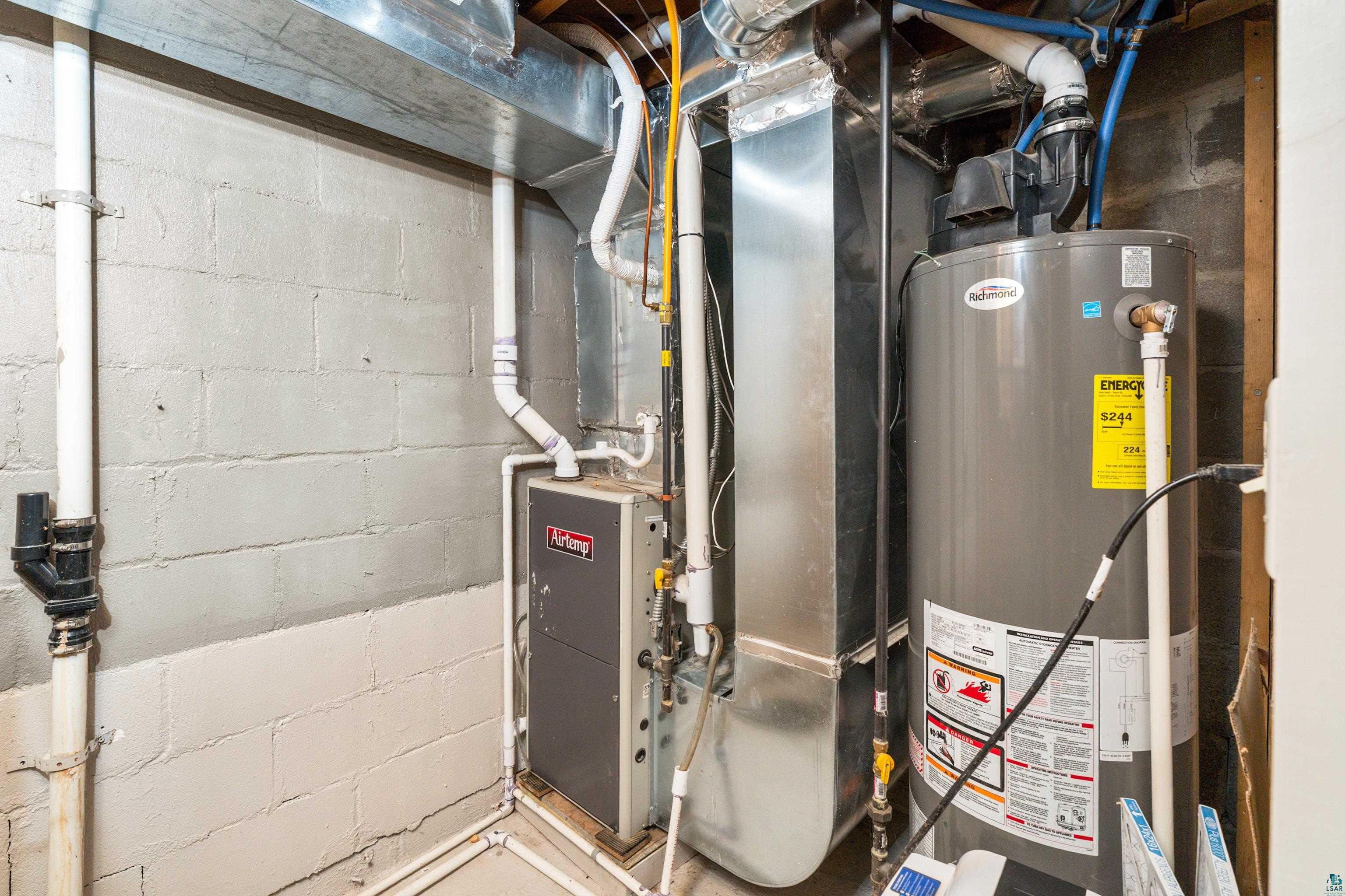 524 14th Avenue Two Harbors, MN 55616 - Photo 28 of 36 Utility room featuring water heater and heating unit