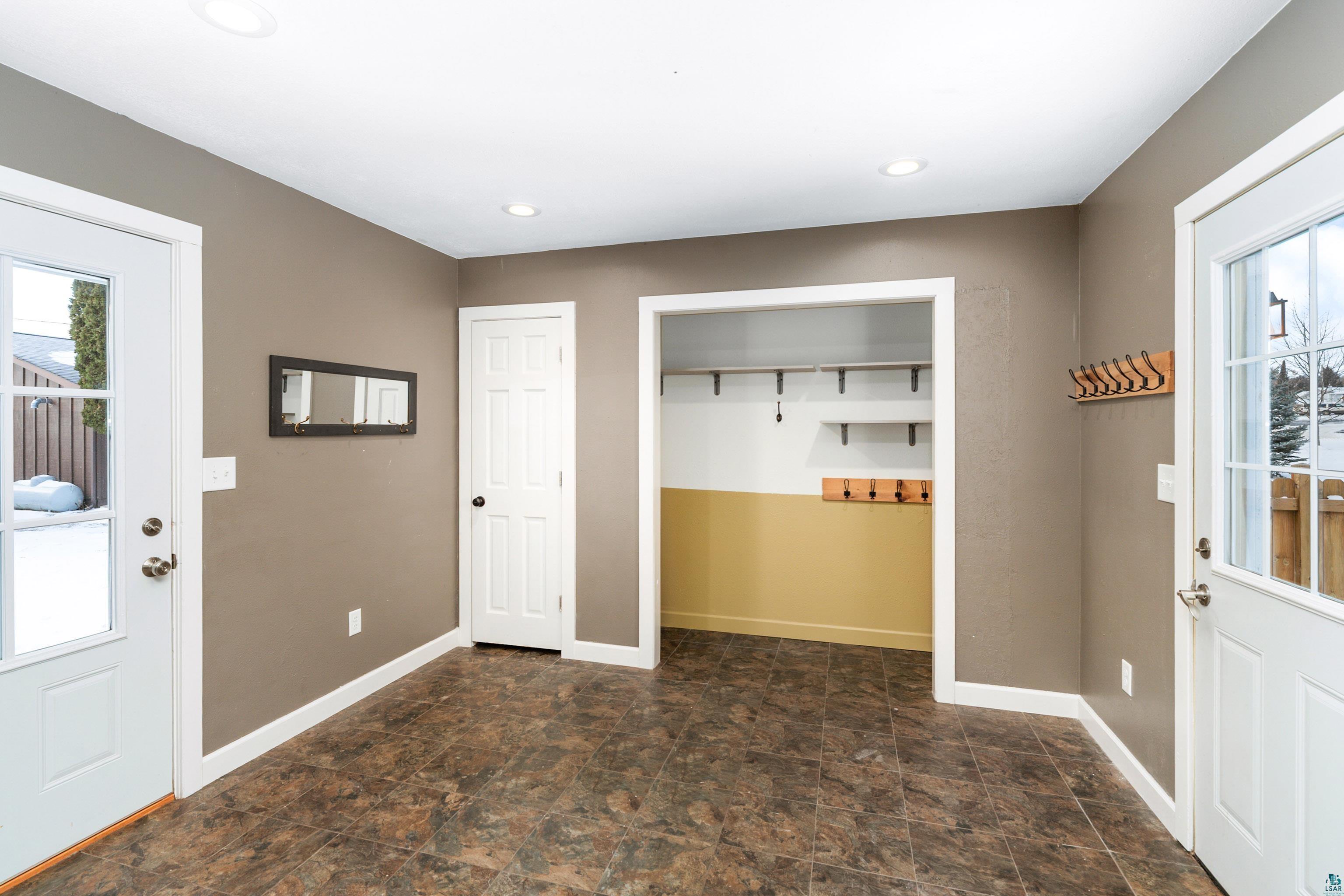 524 14th Avenue Two Harbors, MN 55616 - Photo 3 of 36 Foyer entrance with plenty of natural light, stone finish flooring, and recessed lighting
