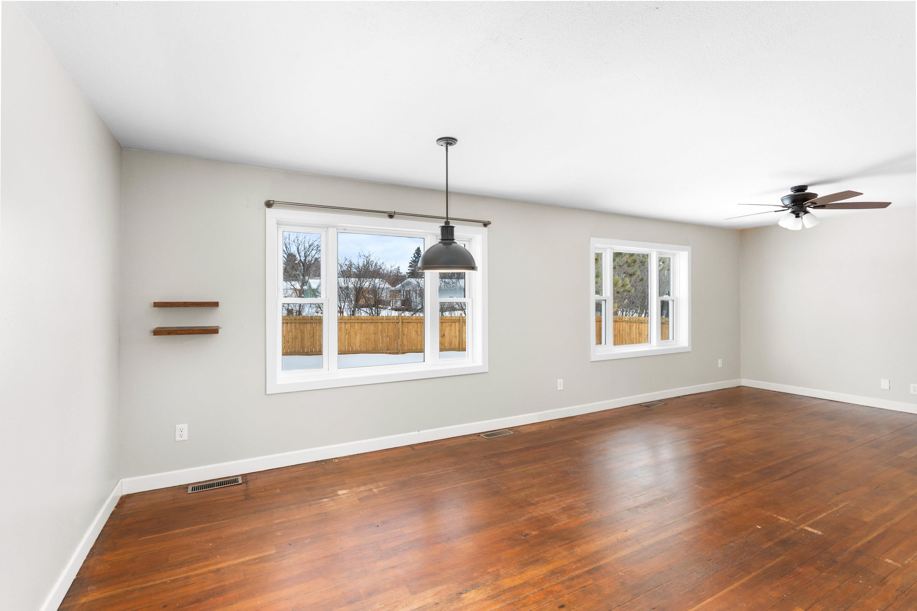 524 14th Avenue Two Harbors, MN 55616 - Photo 9 of 36 Spare room with healthy amount of natural light, dark wood-type flooring, and a ceiling fan