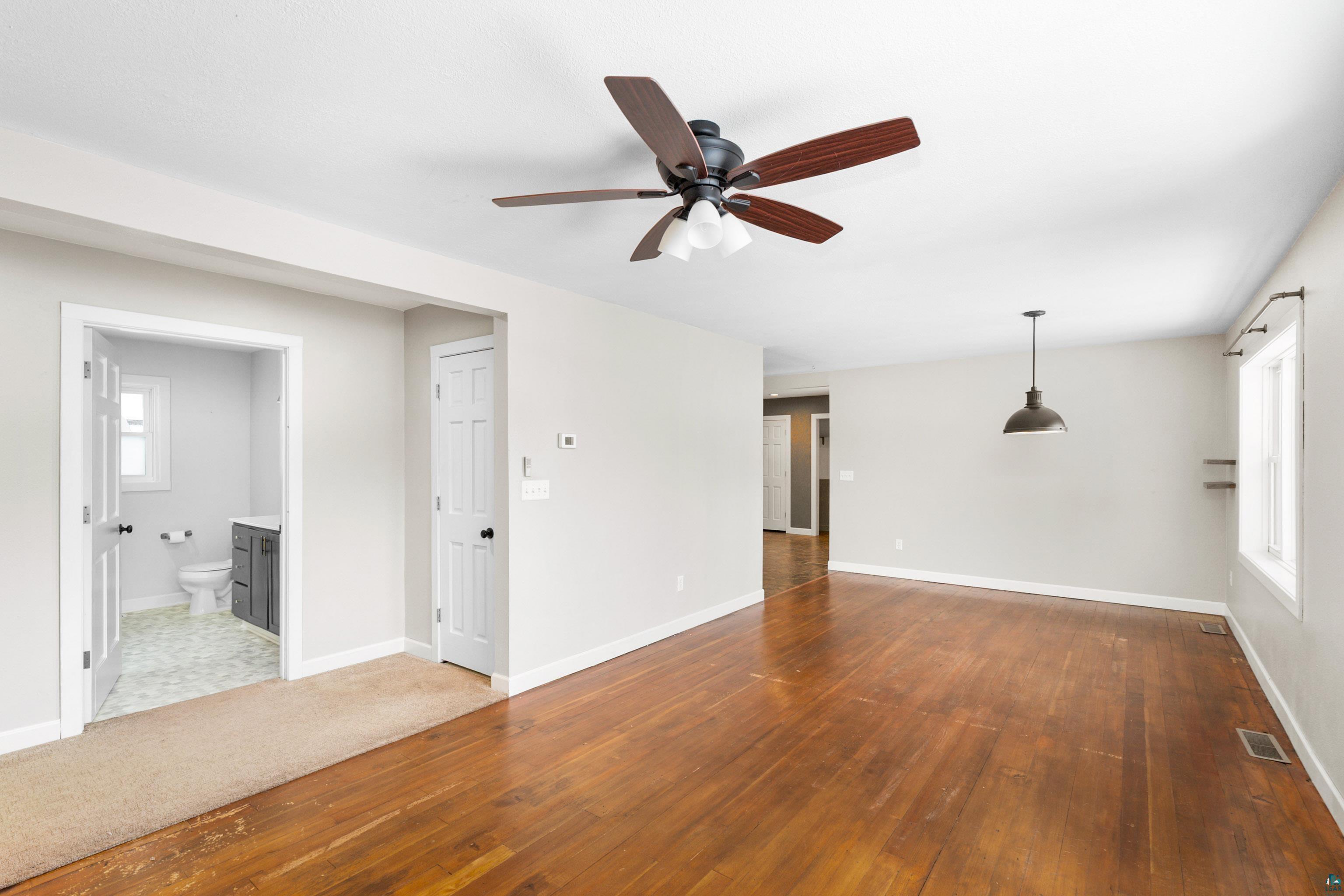 524 14th Avenue Two Harbors, MN 55616 - Photo 10 of 36 Unfurnished living room featuring wood-type flooring and ceiling fan