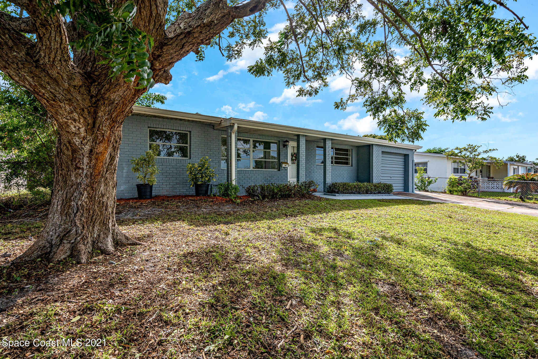 2127 Fatzler Road Melbourne, FL 32935 - Photo 1 of 21 a front view of house with yard and trees around