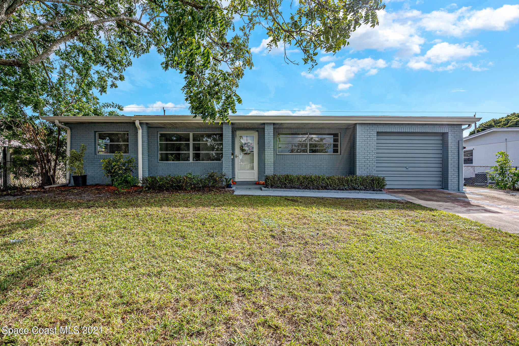 2127 Fatzler Road Melbourne, FL 32935 - Photo 2 of 21 a front view of house with yard and trees in the background