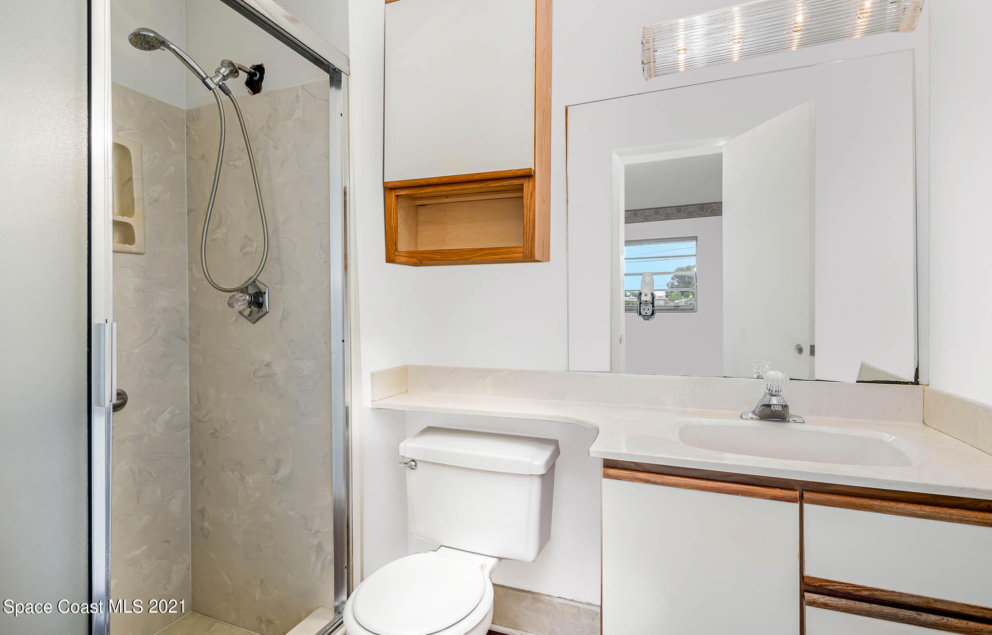 2127 Fatzler Road Melbourne, FL 32935 - Photo 14 of 21 a bathroom with a sink a toilet and shower