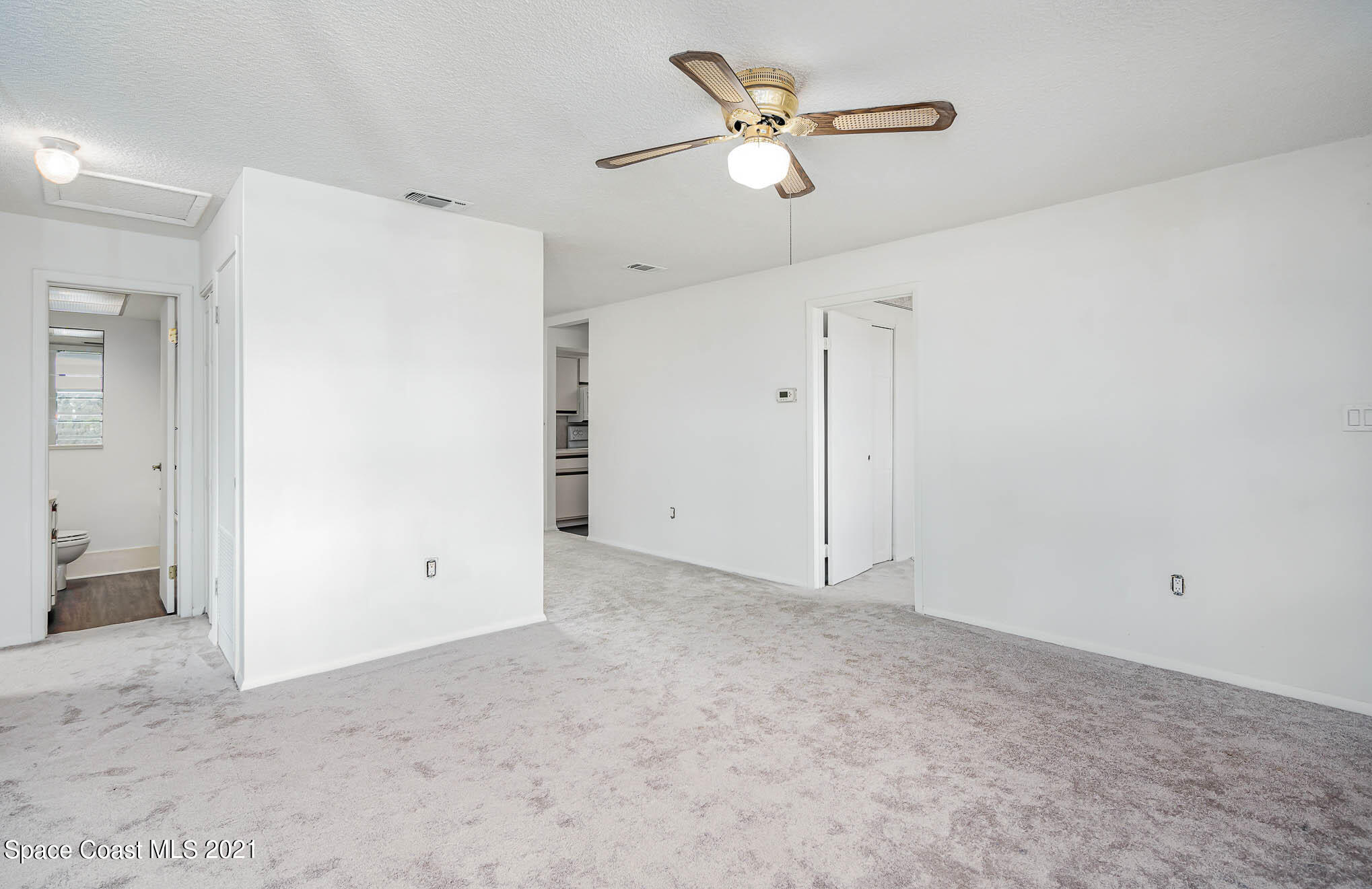 2127 Fatzler Road Melbourne, FL 32935 - Photo 5 of 21 an empty room with closet and fan