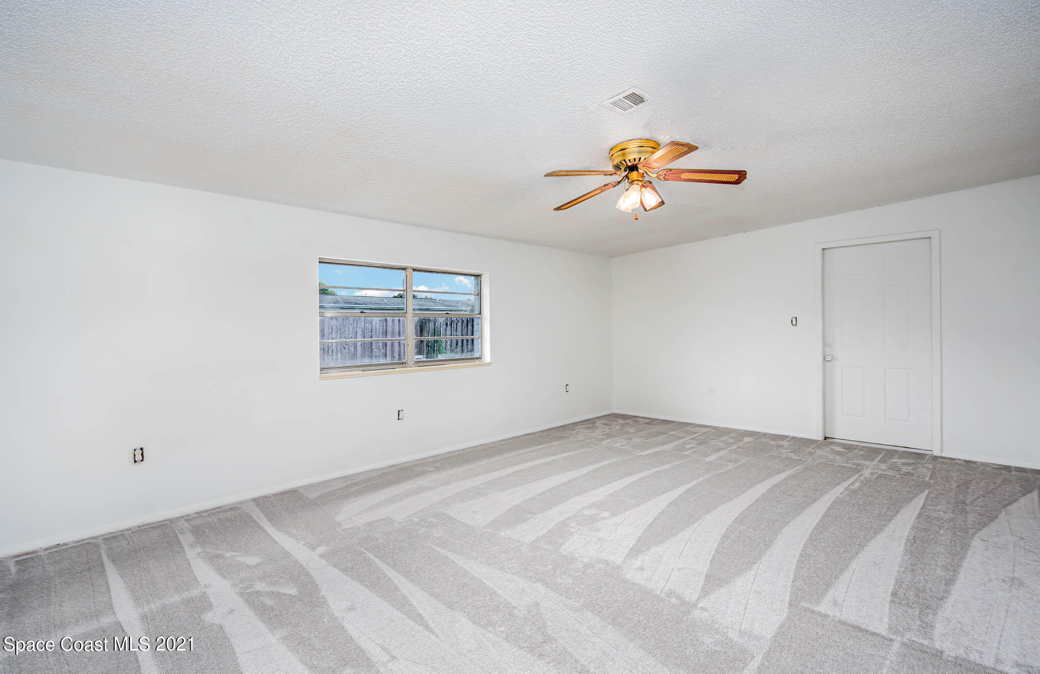 2127 Fatzler Road Melbourne, FL 32935 - Photo 6 of 21 a view of an empty room with a window