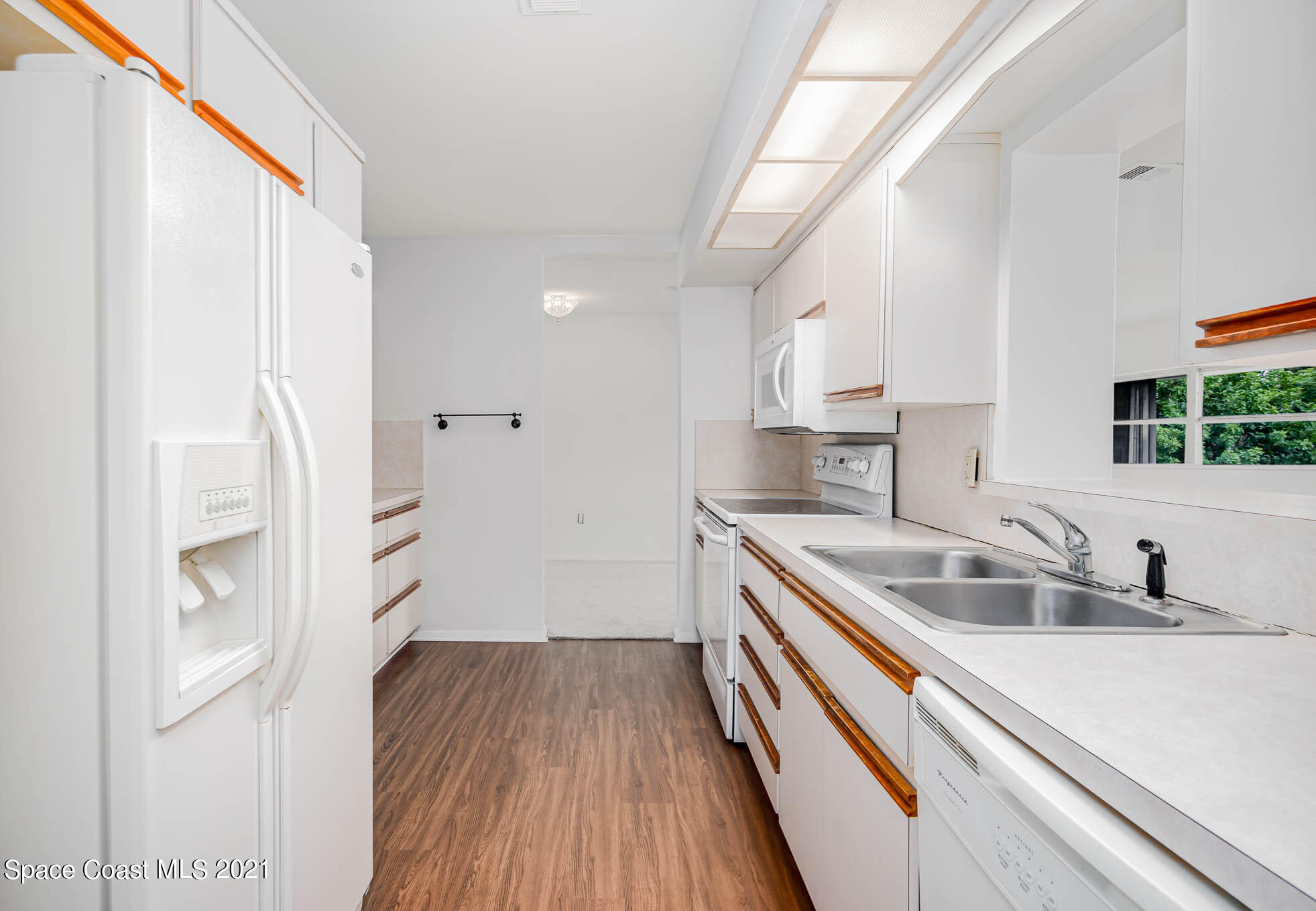 2127 Fatzler Road Melbourne, FL 32935 - Photo 8 of 21 a kitchen with a sink and wooden floor