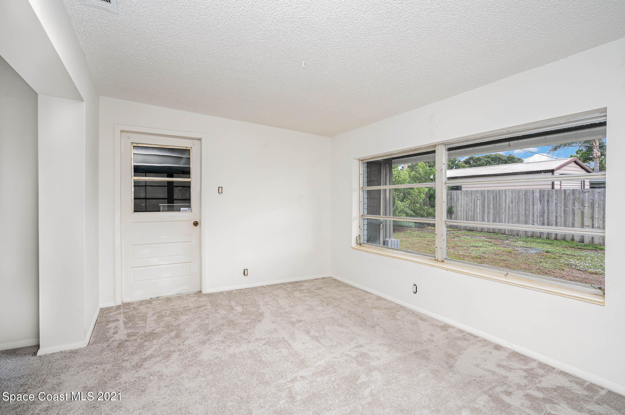 2127 Fatzler Road Melbourne, FL 32935 - Photo 9 of 21 an empty room with windows