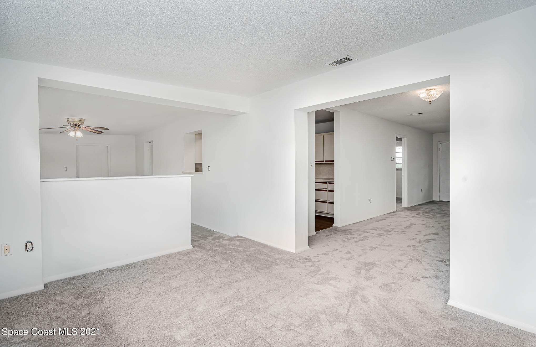 2127 Fatzler Road Melbourne, FL 32935 - Photo 10 of 21 wooden floor and cabinet in a room