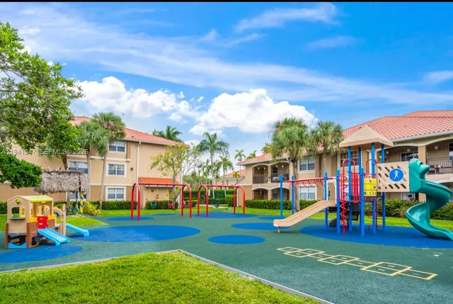 a view of outdoor space with playground and mountain view