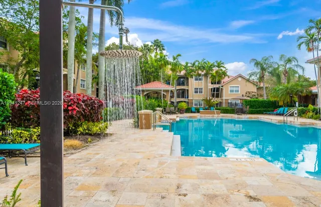 a view of a house with a yard balcony and sitting area