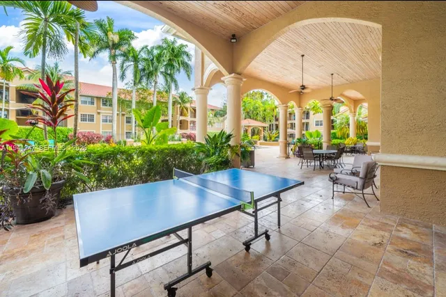 a view of a patio with a table and chairs