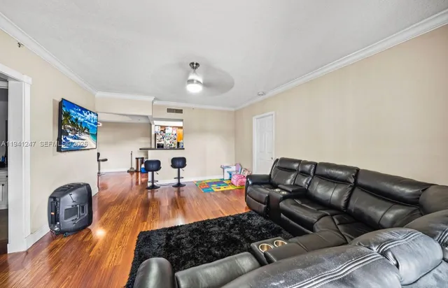 a living room with furniture and wooden floor