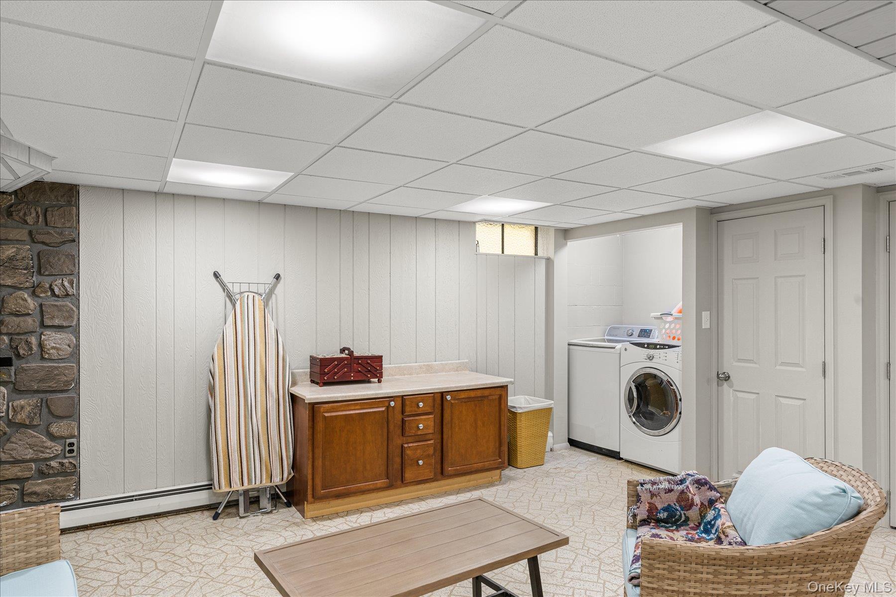 6 George Court Miller Place, NY 11764 - Photo 12 of 33 a living room with furniture a flat screen tv and a window