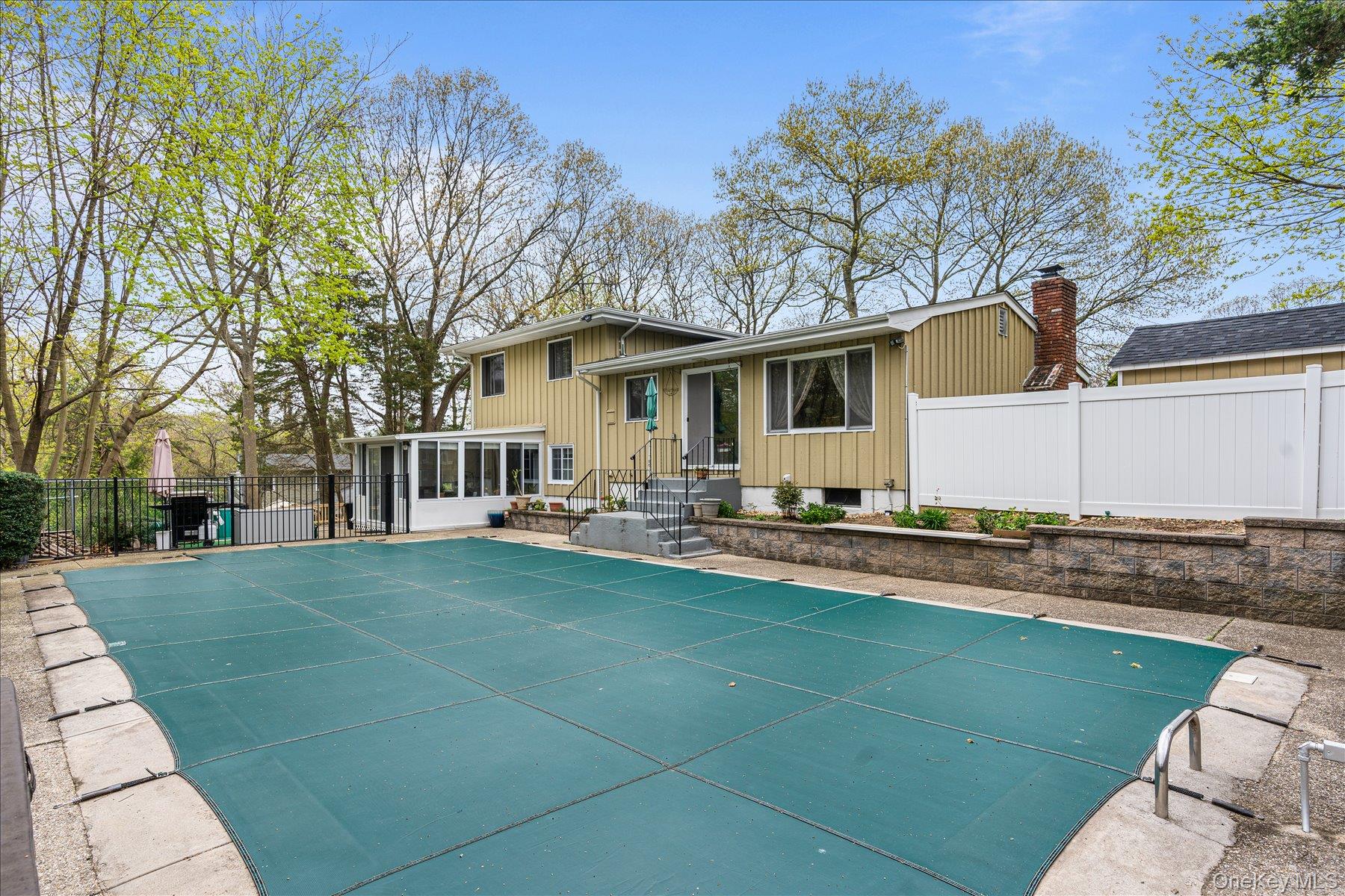 6 George Court Miller Place, NY 11764 - Photo 20 of 33 a front view of a house with swimming pool having outdoor seating