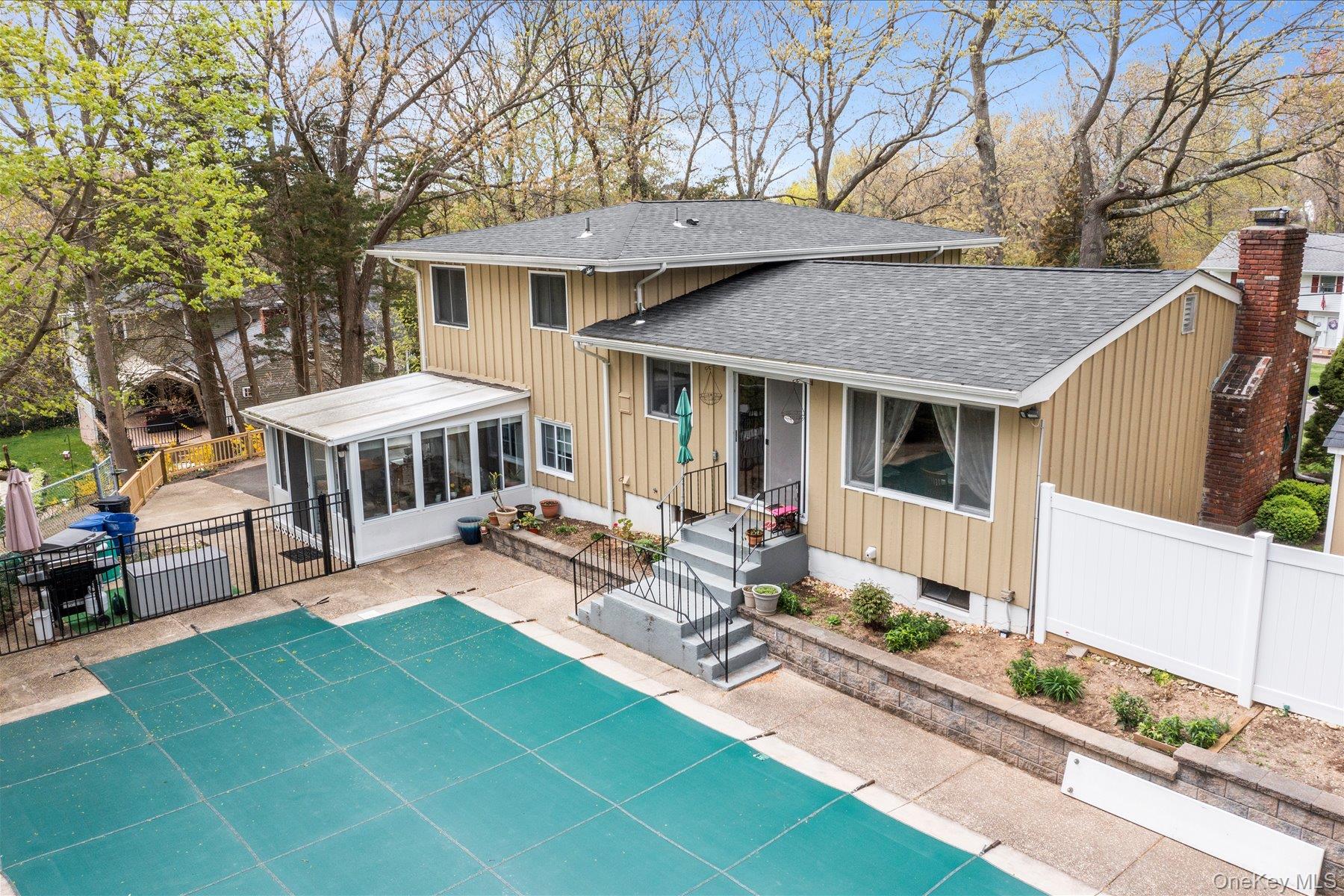 6 George Court Miller Place, NY 11764 - Photo 27 of 33 a view of a house with patio and a yard