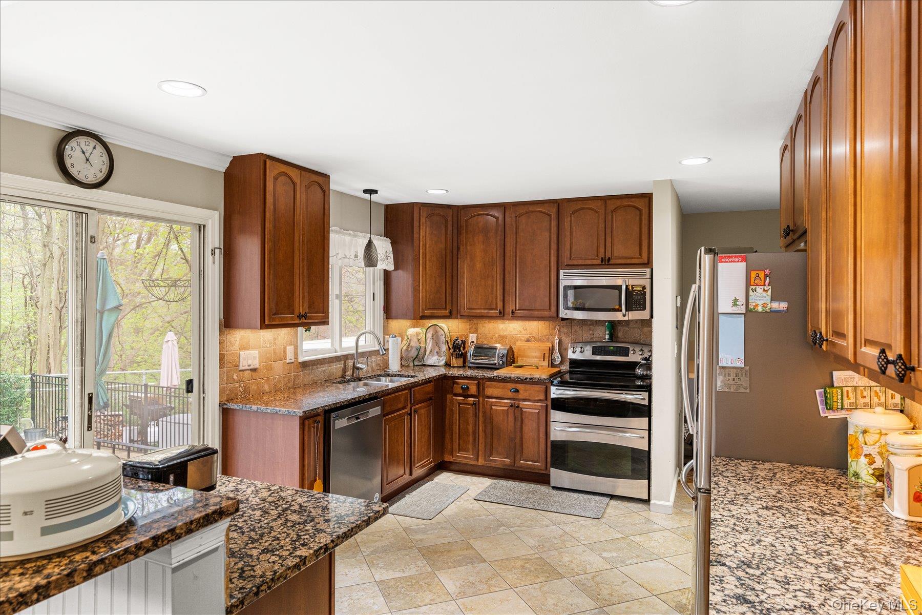 6 George Court Miller Place, NY 11764 - Photo 6 of 33 a kitchen with stainless steel appliances granite countertop a stove a sink and a refrigerator