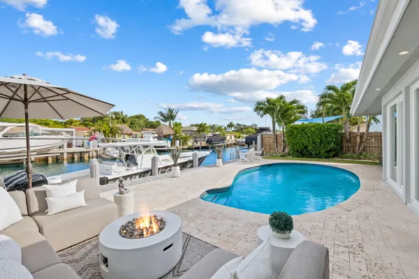 a view of a swimming pool with outdoor seating