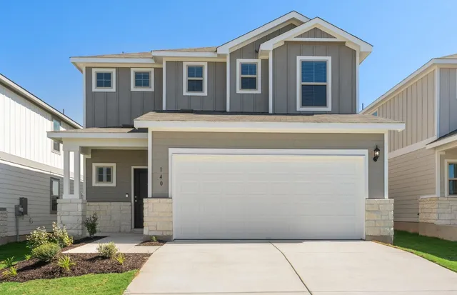 a front view of a house with a garage