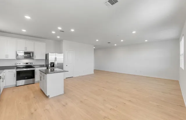 a kitchen with a refrigerator stove microwave and sink