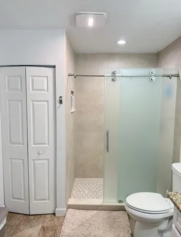 a bathroom with a shower and a toilet
