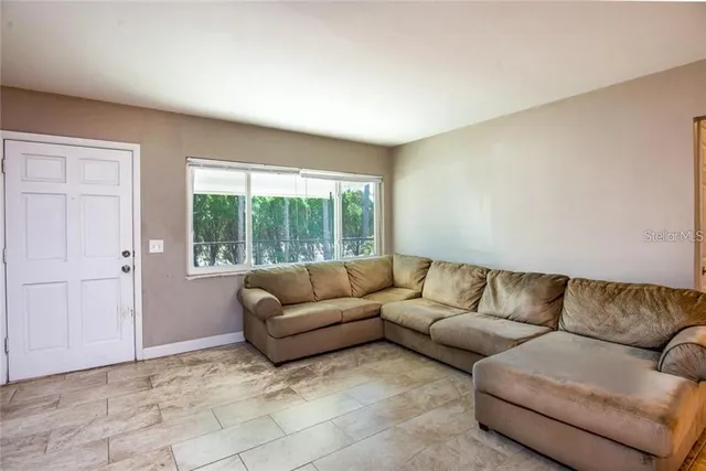 a living room with furniture and a window
