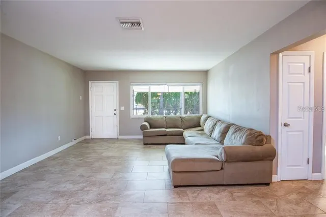 a living room with furniture and a window