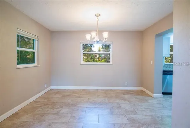 an empty room with windows and entrance