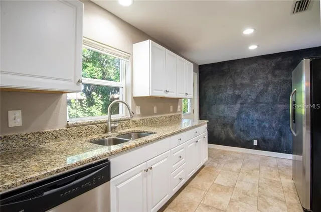 a kitchen with a sink and a window