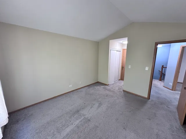 an empty room with closet and mirror
