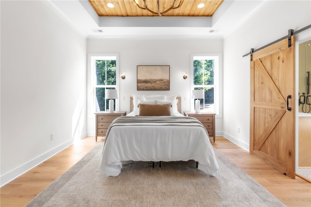 574 Paramount Drive Seneca, SC 29678 - Photo 21 of 45 A tranquil primary bedroom suite with warm wood accents and abundant natural light.
