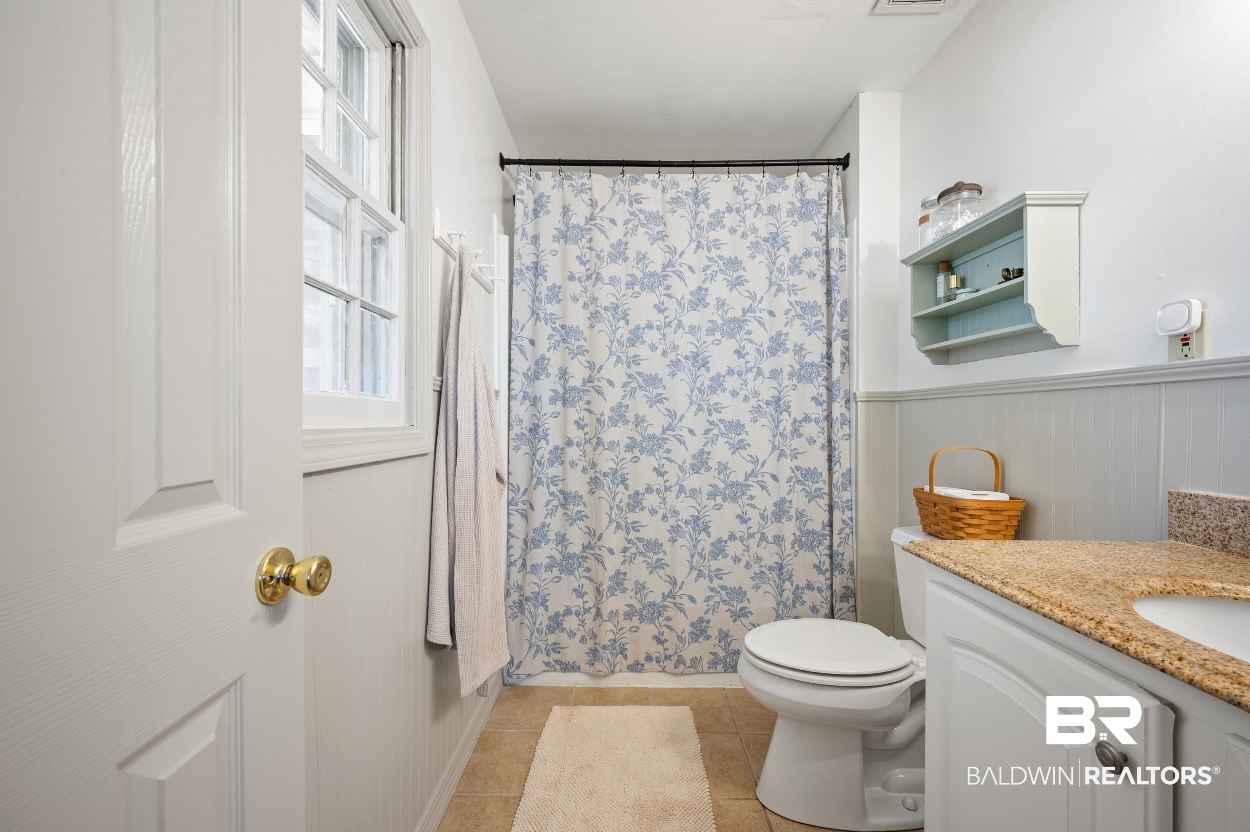 809 Moog Avenue Bay Minette, AL 36507 - Photo 24 of 33 Full bathroom with vanity, a shower with shower curtain, wainscoting, and light tile patterned floors