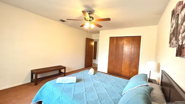 a living room with furniture and a ceiling fan