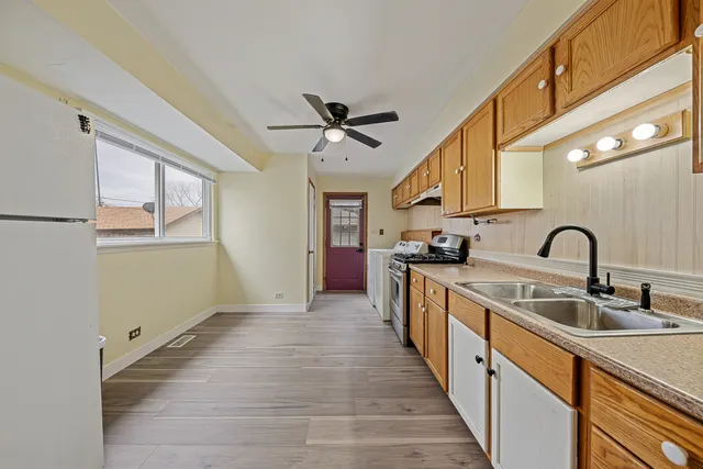 a kitchen with stainless steel appliances granite countertop a sink and cabinets