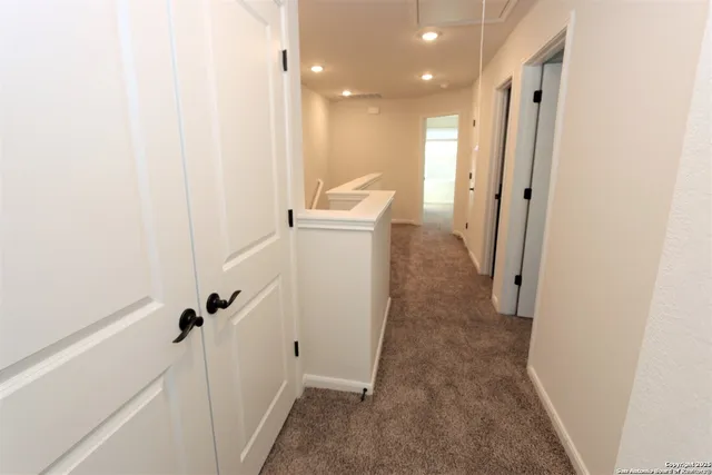 a view of a hallway with white walls