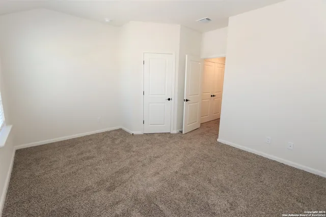 a view of backyard with wooden fence